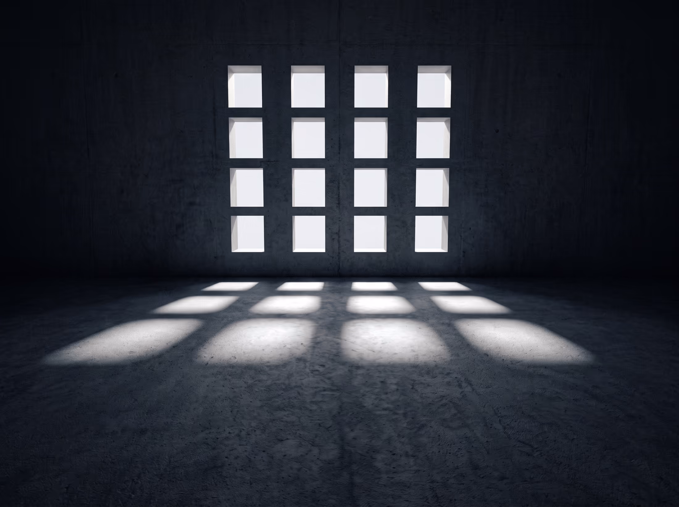 An empty concrete hall with a repeating grid of square openings