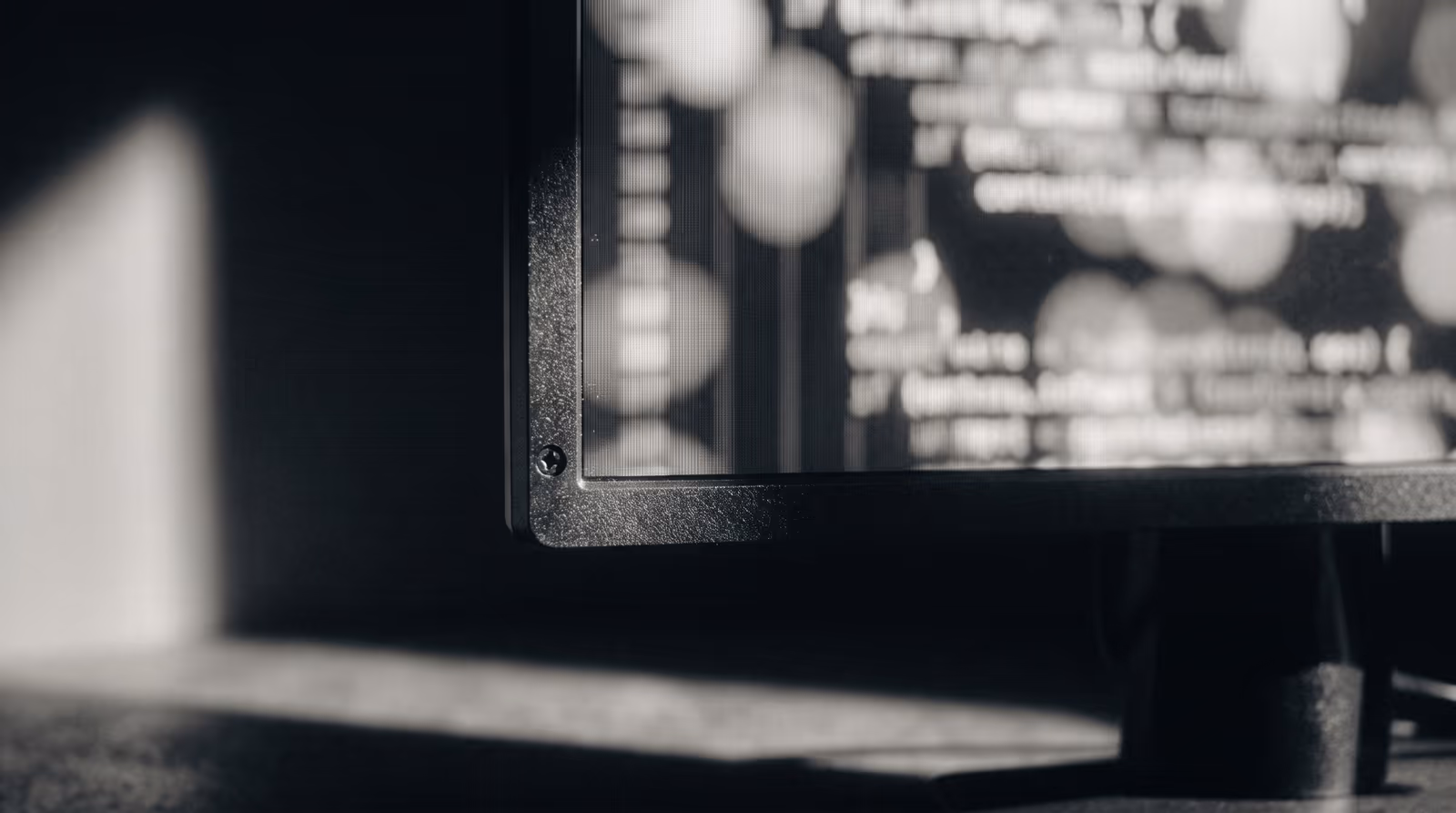 Macro view of a code editor, characters dissolved into bokeh