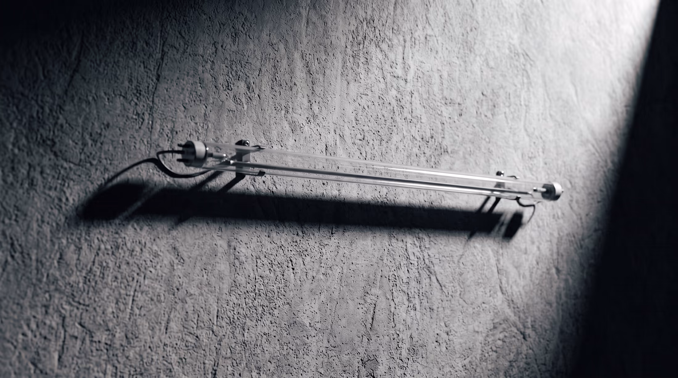 An unlit neon tube mounted on a concrete wall
